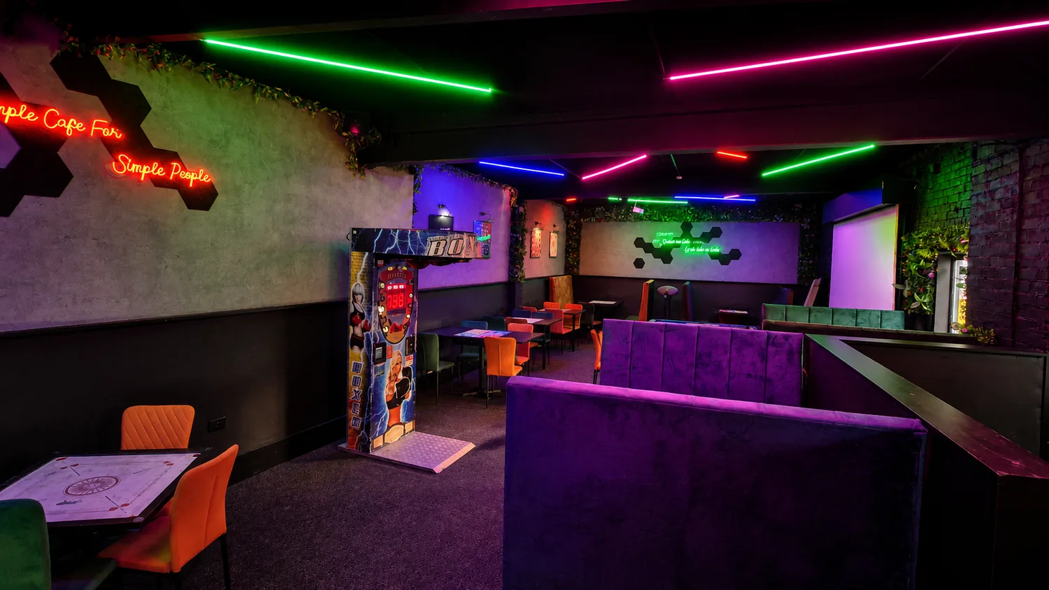 The Board Game Cafe interior with neon gaming tables